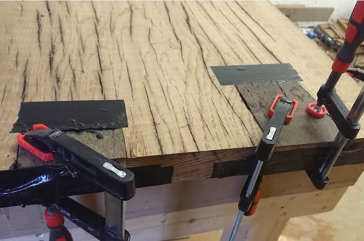 Oak top under clamps with black fill going into the checks